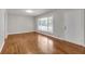 Sunlit living room featuring beautiful hardwood floors, a large window, and a freshly painted interior at 2740 Pasco Se Ln, Atlanta, GA 30316