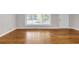 Bright living room with gleaming hardwood floors, large window, and fresh neutral paint at 2740 Pasco Se Ln, Atlanta, GA 30316