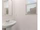 Bright bathroom featuring a pedestal sink and window with blinds at 460 Reflection Dr # 21, Stockbridge, GA 30281