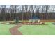 Playground and gazebo in a common area connected by a gravel walking path surrounded by lush green lawns at 460 Reflection Dr # 21, Stockbridge, GA 30281