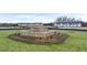 Circular landscaped entrance with a stone water feature and views of the community's new townhomes at 460 Reflection Dr # 21, Stockbridge, GA 30281