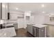 Open kitchen features granite countertops, stainless steel appliances, island, and a view into living area at 460 Reflection Dr # 21, Stockbridge, GA 30281