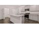 Modern kitchen featuring an island, stainless steel appliances, granite countertops, and ample cabinet space at 460 Reflection Dr # 21, Stockbridge, GA 30281