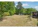 The expansive backyard, surrounded by lush greenery, provides an ideal canvas for outdoor activities and relaxation at 2944 Williams Pl, Snellville, GA 30078