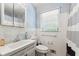 Cozy bathroom with white tiles, a sink, and a window at 2944 Williams Pl, Snellville, GA 30078