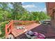 An outdoor deck with a wooden railing offers views of the wooded backyard and natural surroundings at 2944 Williams Pl, Snellville, GA 30078