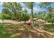 A manicured front yard displays a charming brick home with blooming azaleas in a serene residential setting at 2944 Williams Pl, Snellville, GA 30078