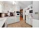 Bright eat-in kitchen with white cabinetry, a ceiling fan, and easy access to the living areas at 2944 Williams Pl, Snellville, GA 30078