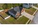 Aerial view of this traditional brick home with a 3-car garage, front yard, and landscaping at 4499 Bellemeade Dr, Douglasville, GA 30135