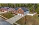 Aerial view of this traditional brick home with a 3-car garage and large driveway at 4499 Bellemeade Dr, Douglasville, GA 30135