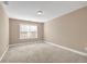 Bright bedroom featuring neutral carpet, beige walls, and a window with blinds at 4499 Bellemeade Dr, Douglasville, GA 30135