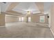 Spacious bedroom featuring a tray ceiling, ceiling fan, neutral paint, and ample natural light from multiple windows at 4499 Bellemeade Dr, Douglasville, GA 30135