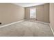 Bedroom featuring neutral carpet, beige walls, and a window with blinds at 4499 Bellemeade Dr, Douglasville, GA 30135