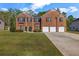 Lovely brick home with a three-car garage, manicured lawn, and beautiful landscaping at 4499 Bellemeade Dr, Douglasville, GA 30135
