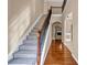 Bright foyer featuring hardwood floors, staircase with iron railings, and elegant archways at 4499 Bellemeade Dr, Douglasville, GA 30135