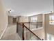 Upper hallway featuring neutral carpet, wood railings, and decorative chandelier lighting at 4499 Bellemeade Dr, Douglasville, GA 30135