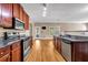 A kitchen featuring wood cabinets, granite countertops, stainless steel appliances, and wood-look flooring at 4499 Bellemeade Dr, Douglasville, GA 30135