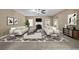 Staged living room showcasing large windows, fireplace, and comfortable seating area at 4499 Bellemeade Dr, Douglasville, GA 30135