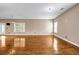 Bright and airy living room showcasing wood floors, neutral walls, and natural light from large windows at 4499 Bellemeade Dr, Douglasville, GA 30135