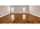 Spacious room featuring laminate flooring, neutral paint, natural light from two windows, and simple modern finishes at 4499 Bellemeade Dr, Douglasville, GA 30135