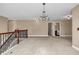Large loft area with neutral carpet and wood railings leading to the staircase at 4499 Bellemeade Dr, Douglasville, GA 30135