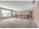 Large loft area with neutral carpet, wood railings, and a chandelier light fixture at 4499 Bellemeade Dr, Douglasville, GA 30135