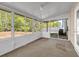Bright sunroom surrounded by multiple windows and a sliding door to exterior at 4499 Bellemeade Dr, Douglasville, GA 30135