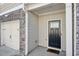 Front door with a black door and stone and brick accent at 5853 Greystone Dr, Lithonia, GA 30058