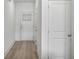 Clean hallway with light-colored wood floors and white walls at 5853 Greystone Dr, Lithonia, GA 30058