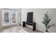 Bright living room featuring wood floors, minimalist decor, and access to an outdoor patio area at 5853 Greystone Dr, Lithonia, GA 30058