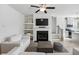 Cozy living room with a fireplace, built-in shelves, and stairs to the upper level at 5853 Greystone Dr, Lithonia, GA 30058