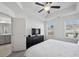 Spacious primary bedroom with a ceiling fan and a view to the adjoining bathroom at 5853 Greystone Dr, Lithonia, GA 30058