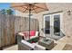 Relaxing outdoor patio with brick, seating area, and adjacent fenced yard at 5853 Greystone Dr, Lithonia, GA 30058