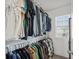 Organized walk-in closet offering ample hanging space and storage shelves at 5853 Greystone Dr, Lithonia, GA 30058