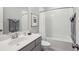 Clean bathroom featuring a white subway-tiled shower/tub combo, gray vanity, and soft gray walls at 613 Brennan Dr, Decatur, GA 30033