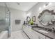 Modern bathroom with dual sinks, marble countertops, glass shower, and stylish mirrors at 613 Brennan Dr, Decatur, GA 30033
