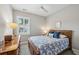 Serene bedroom featuring a comfortable bed with blue accents, hardwood dresser, and bright window at 613 Brennan Dr, Decatur, GA 30033