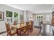 Open dining room with dark floors, leading to a modern kitchen and backyard at 613 Brennan Dr, Decatur, GA 30033