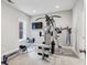 Home gym featuring modern equipment, natural light from the window, and wall-mounted television for entertainment at 613 Brennan Dr, Decatur, GA 30033