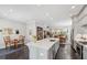 Open concept kitchen with island seating area, modern appliances, and view into dining and living rooms at 613 Brennan Dr, Decatur, GA 30033
