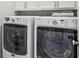 Convenient laundry room with a modern washer and dryer, cabinets, and stacked folded towels at 613 Brennan Dr, Decatur, GA 30033