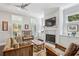 Bright living room with fireplace, built-ins, fan, and stylish furniture at 613 Brennan Dr, Decatur, GA 30033