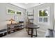 Bright home office featuring two windows, shelving, a round table, and neutral walls at 613 Brennan Dr, Decatur, GA 30033