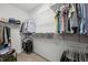 Organized walk-in closet featuring shelves, hanging rods, clothing, shoes, and storage boxes at 613 Brennan Dr, Decatur, GA 30033