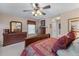 Spacious bedroom with neutral walls, plush carpet, ceiling fan, and warm lighting at 661 Village Field Nw Ct, Suwanee, GA 30024