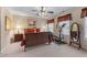 Warm bedroom featuring neutral walls, plush carpet, and a decorative ceiling fan at 661 Village Field Nw Ct, Suwanee, GA 30024