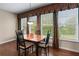 The dining room has hardwood flooring, natural light, and neutral walls at 661 Village Field Nw Ct, Suwanee, GA 30024