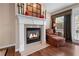 The living room fireplace has an elegant design and hardwood flooring at 661 Village Field Nw Ct, Suwanee, GA 30024