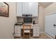 Functional office nook with a built-in desk and overhead cabinets at 661 Village Field Nw Ct, Suwanee, GA 30024