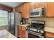Kitchen featuring stainless steel appliances, including a gas stove and refrigerator at 661 Village Field Nw Ct, Suwanee, GA 30024